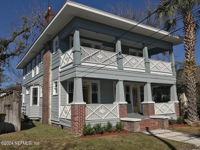 view of front of house featuring covered porch and a balcony