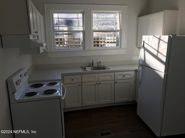 kitchen featuring black fridge, dark hardwood / wood-style flooring, white stove, sink, and white cabinets