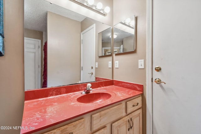 bathroom with vanity and a textured ceiling