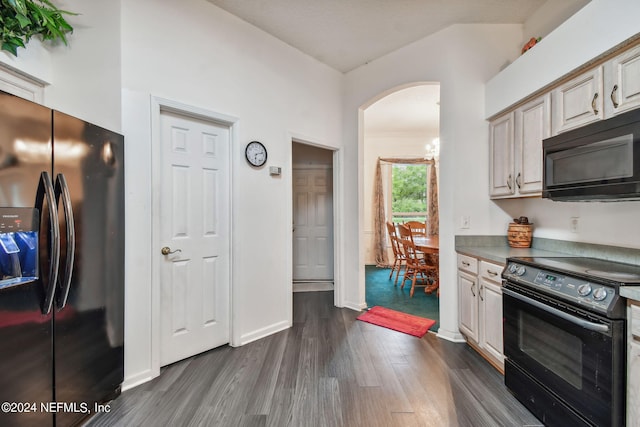 kitchen featuring dark hardwood / wood-style flooring and black appliances