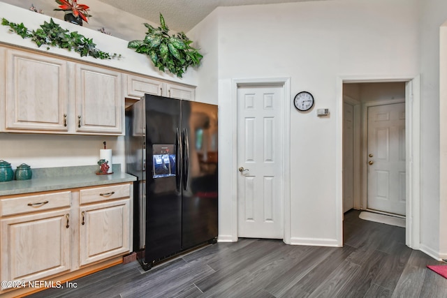 kitchen with high vaulted ceiling, black refrigerator with ice dispenser, dark hardwood / wood-style floors, a textured ceiling, and light brown cabinetry