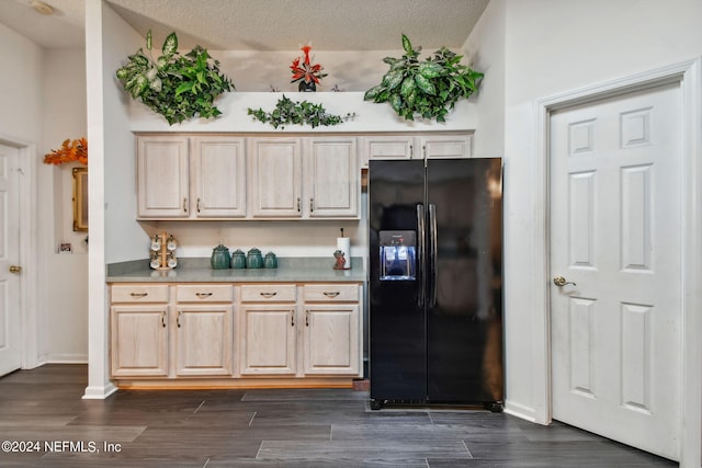 kitchen with high vaulted ceiling, dark wood-type flooring, black refrigerator with ice dispenser, light brown cabinetry, and a textured ceiling