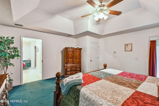 carpeted bedroom featuring a textured ceiling, ceiling fan, and a tray ceiling