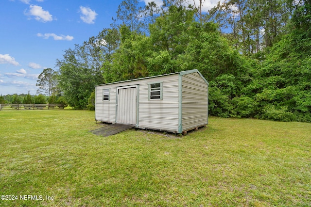 view of shed / structure featuring a yard