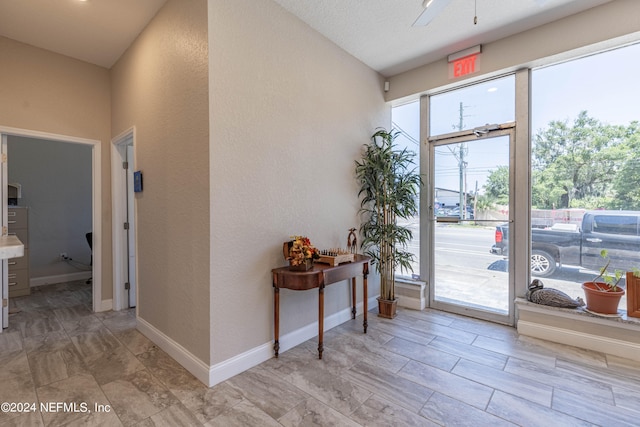 tiled entryway with a wealth of natural light and a textured ceiling