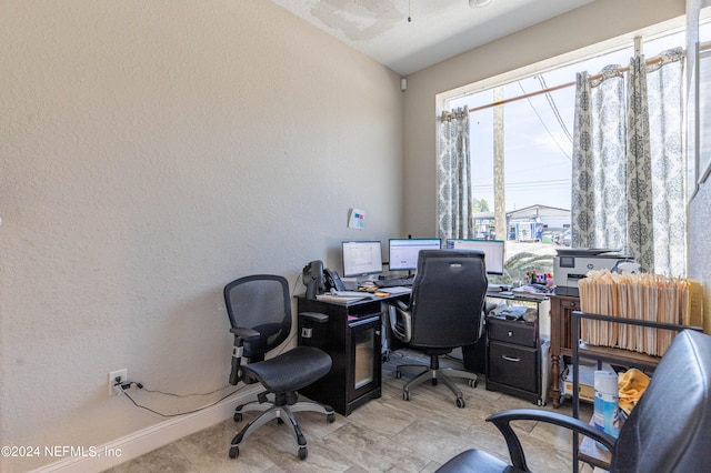 tiled home office featuring lofted ceiling