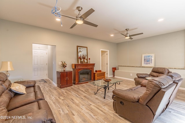 living room with ceiling fan and light hardwood / wood-style flooring