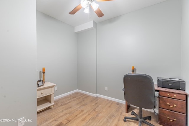 office with light wood-type flooring and ceiling fan