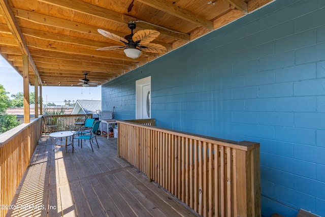 wooden terrace featuring ceiling fan