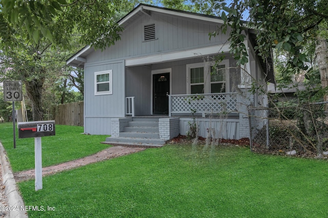 bungalow-style house with a front yard and a porch