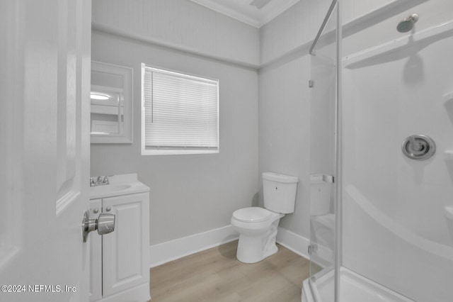 bathroom featuring hardwood / wood-style floors, ornamental molding, vanity, and toilet