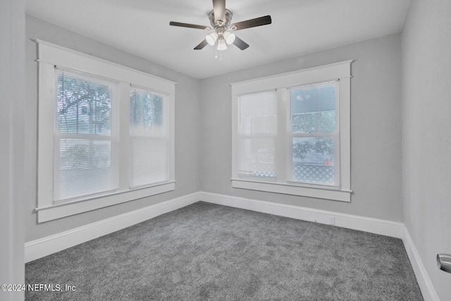 carpeted spare room featuring ceiling fan