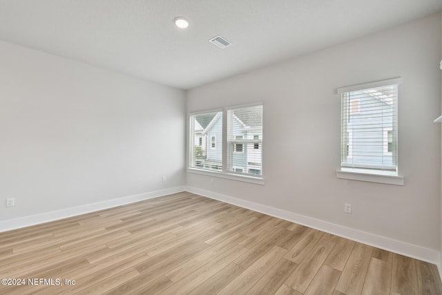 unfurnished room featuring light hardwood / wood-style floors and a wealth of natural light