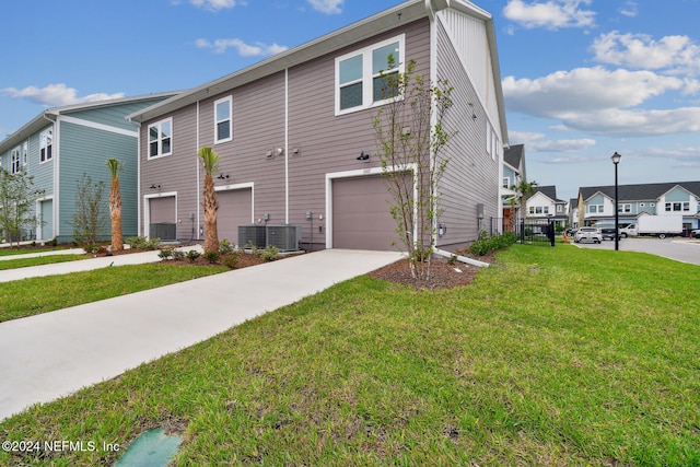 exterior space with a garage and a lawn