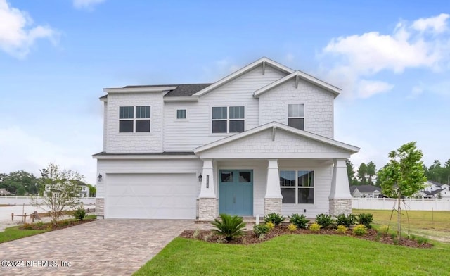 view of front of property featuring a garage and a front lawn