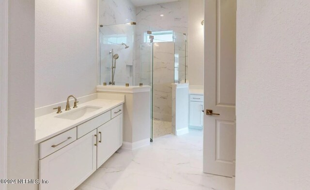 bathroom featuring a tile shower and vanity