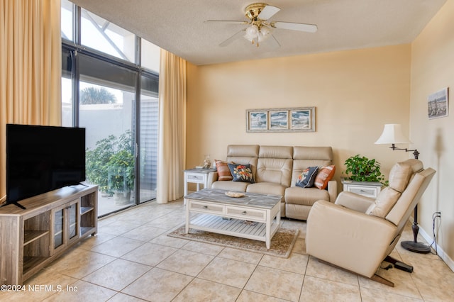 tiled living room with ceiling fan and a textured ceiling