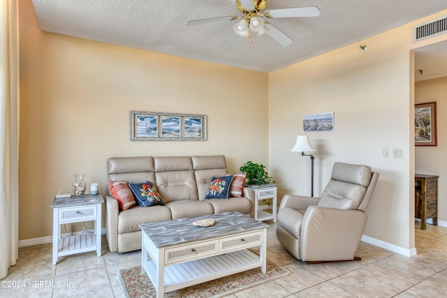 tiled living room featuring a textured ceiling and ceiling fan