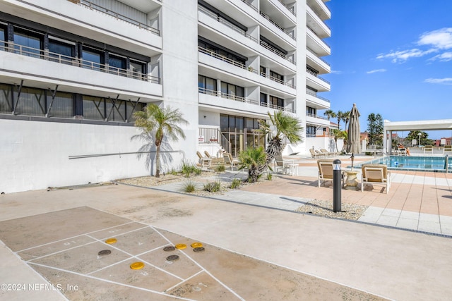 view of home's community with a patio area and a pool