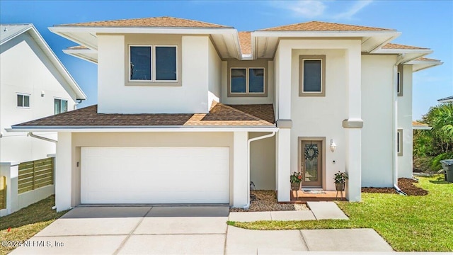 view of front facade featuring a garage and a front yard