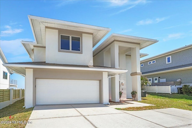 view of front of home featuring a garage and a front yard