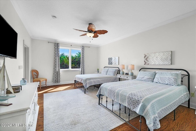 bedroom with a textured ceiling, ceiling fan, crown molding, and hardwood / wood-style flooring