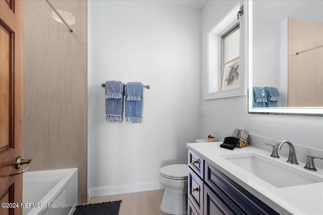 bathroom featuring toilet, vanity, and hardwood / wood-style flooring