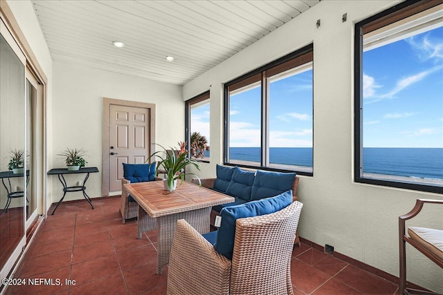 sunroom / solarium with a water view