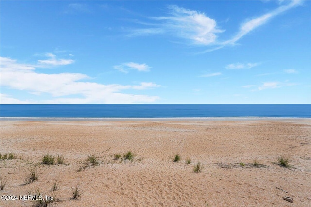 property view of water featuring a beach view