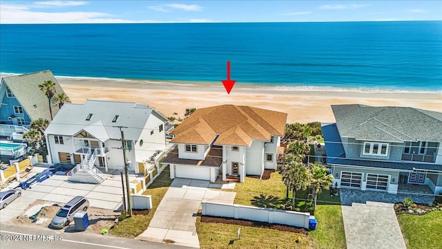 drone / aerial view with a beach view and a water view