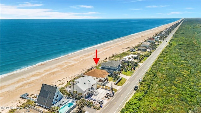 aerial view with a water view and a beach view