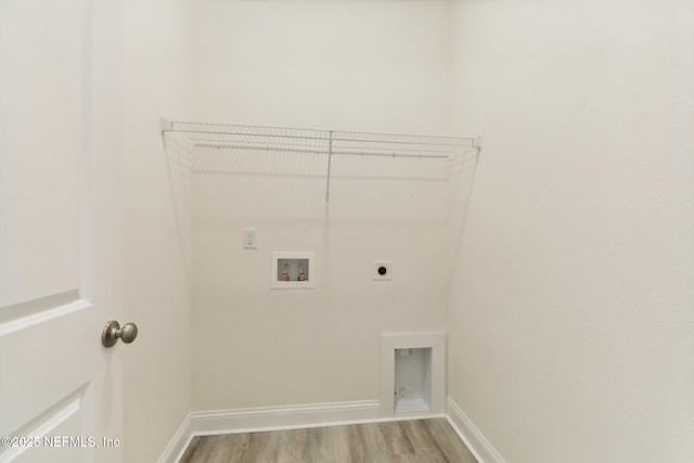 clothes washing area with hookup for a washing machine, light hardwood / wood-style flooring, and hookup for an electric dryer