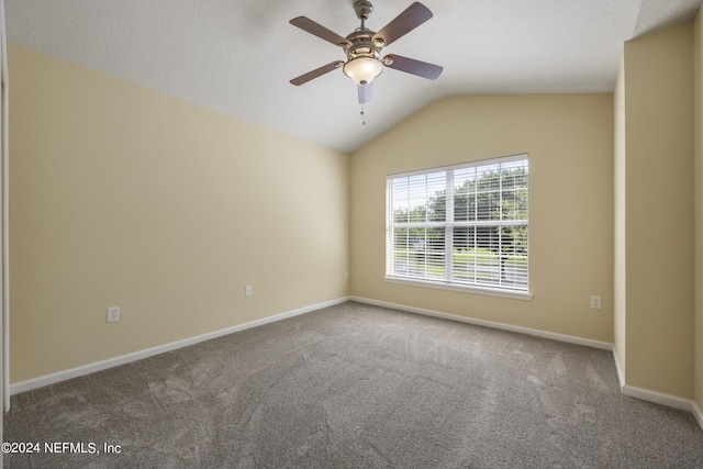 carpeted empty room featuring lofted ceiling and ceiling fan