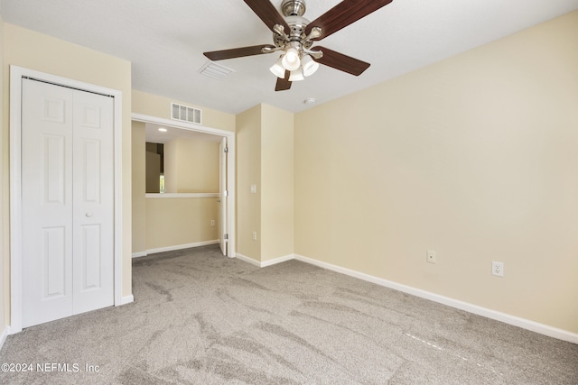 unfurnished bedroom featuring a closet, carpet floors, and ceiling fan