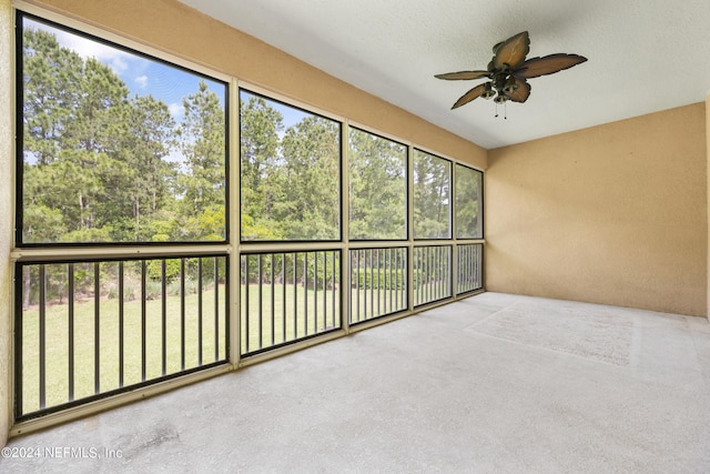 unfurnished sunroom featuring ceiling fan