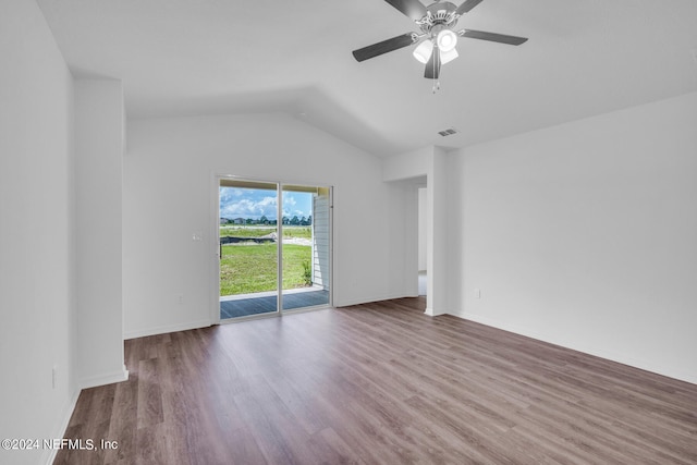 empty room featuring hardwood / wood-style floors, vaulted ceiling, and ceiling fan