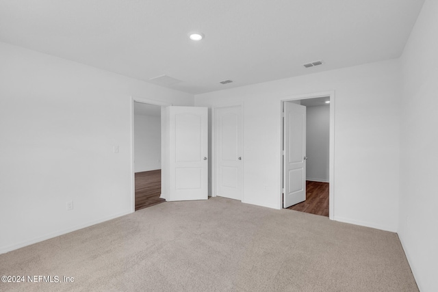 unfurnished bedroom with dark carpet