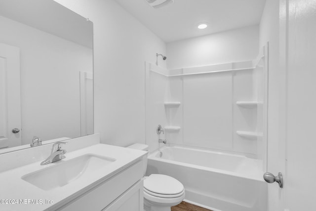 full bathroom featuring wood-type flooring, large vanity, bathing tub / shower combination, and toilet