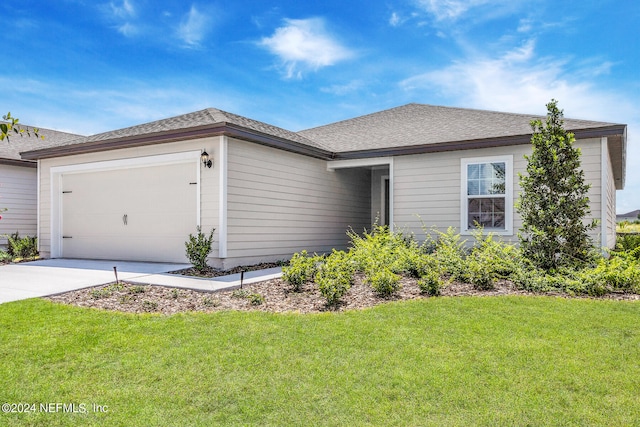 ranch-style home with a garage and a front lawn