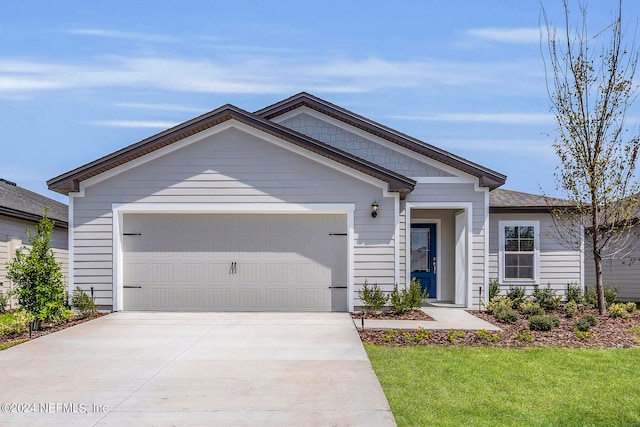 view of front facade featuring a garage and a front lawn