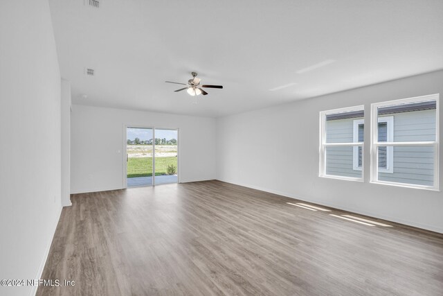 empty room featuring hardwood / wood-style floors and ceiling fan