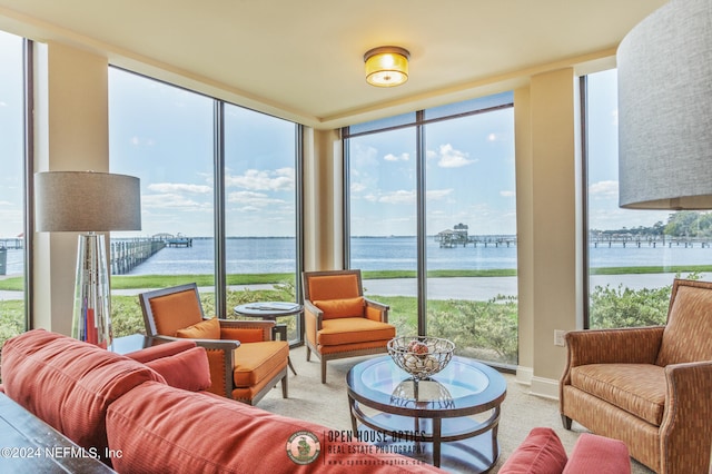 sunroom featuring a water view and plenty of natural light