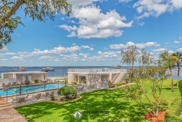 exterior space with a water view, a community pool, and a yard