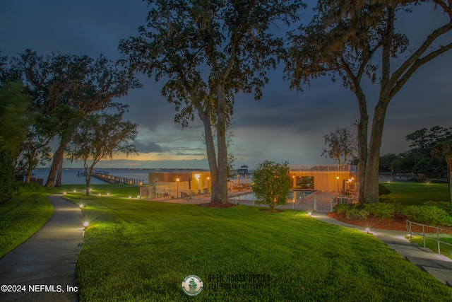 exterior space featuring a lawn and a water view