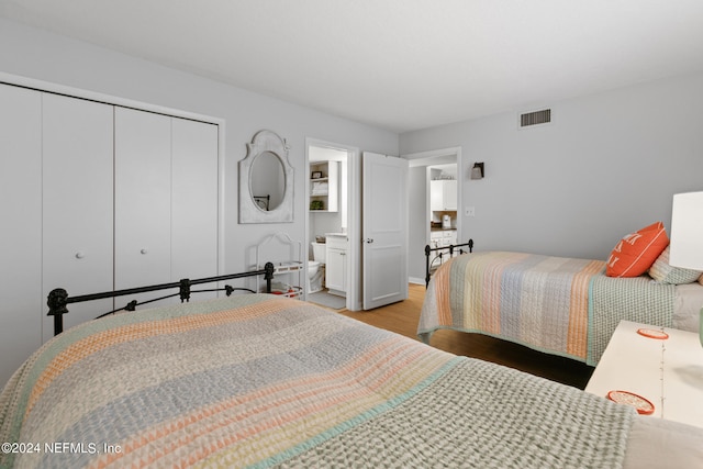 bedroom with a closet and light hardwood / wood-style flooring