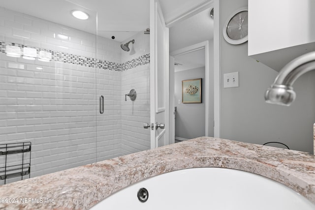 bathroom with an enclosed shower and vanity