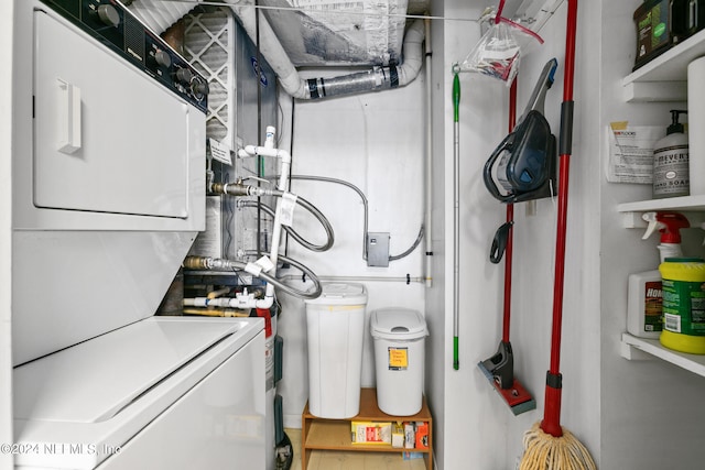 utility room featuring stacked washer and dryer