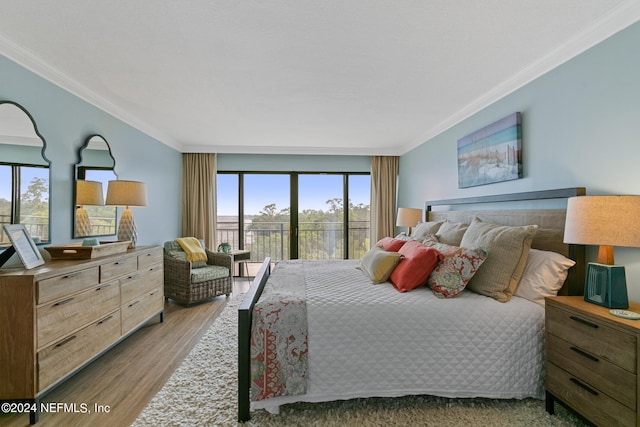 bedroom featuring crown molding, hardwood / wood-style flooring, and multiple windows