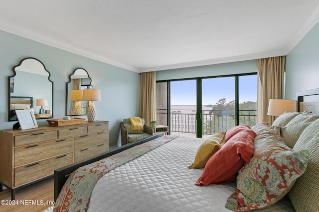 bedroom featuring wood-type flooring, access to exterior, and crown molding