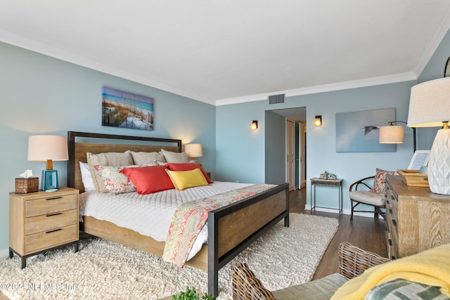 bedroom featuring hardwood / wood-style floors and ornamental molding